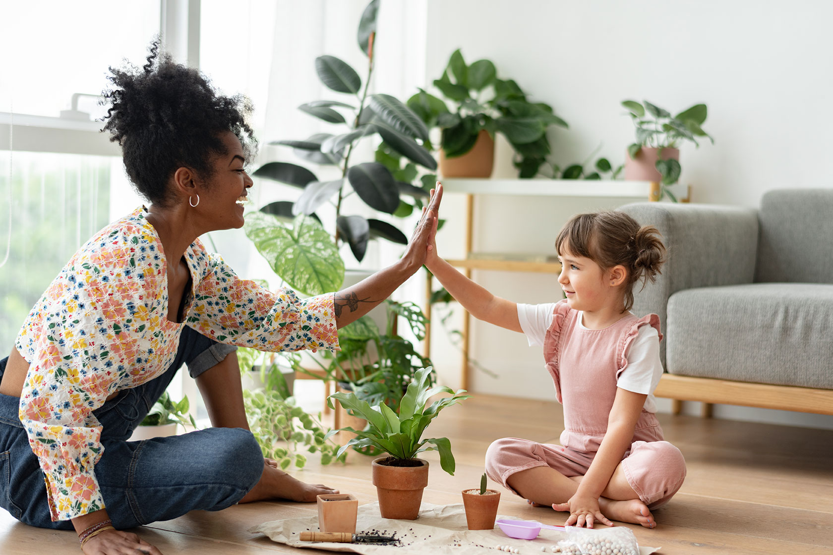 home-slider2-multiracial-family-high-five-while-indoor-gardening